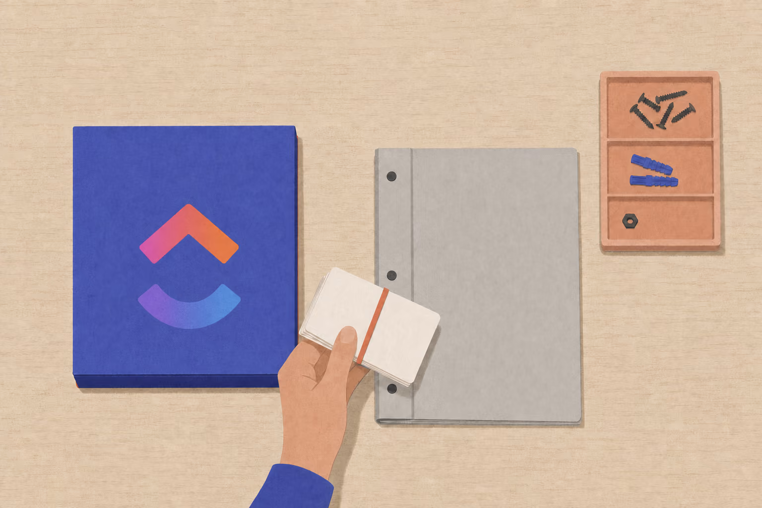 A hand moves bundled ticket cards from a developer binder toward a task box beside a parts tray