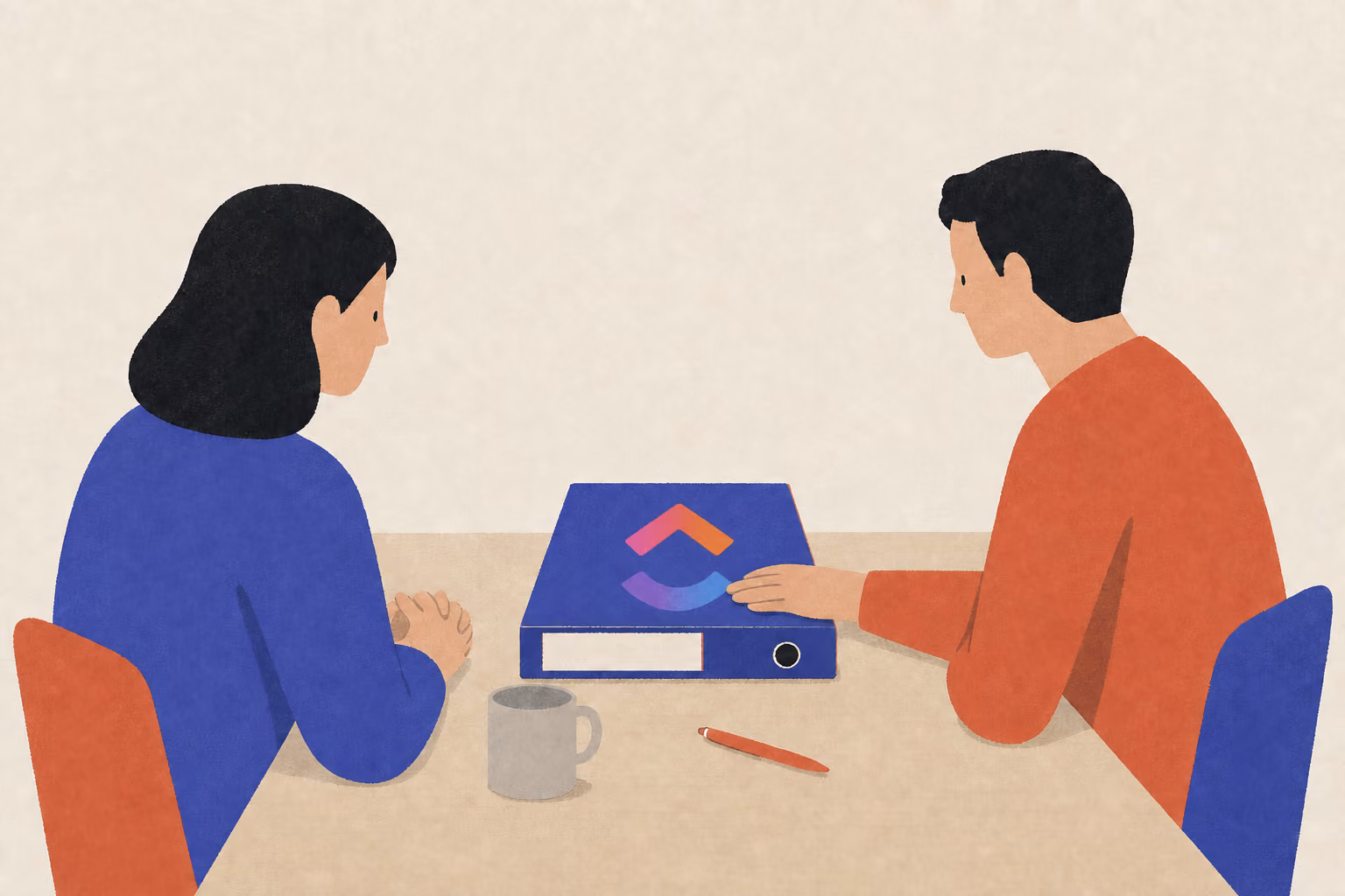 Two people at a desk with a closed ring binder between them, one turned away